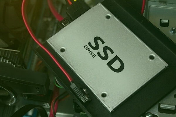 SSD drive laying on an open computer tower